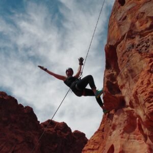 Adventurous woman practicing mountain climbing, outdoor activities, rusk takers, achievements