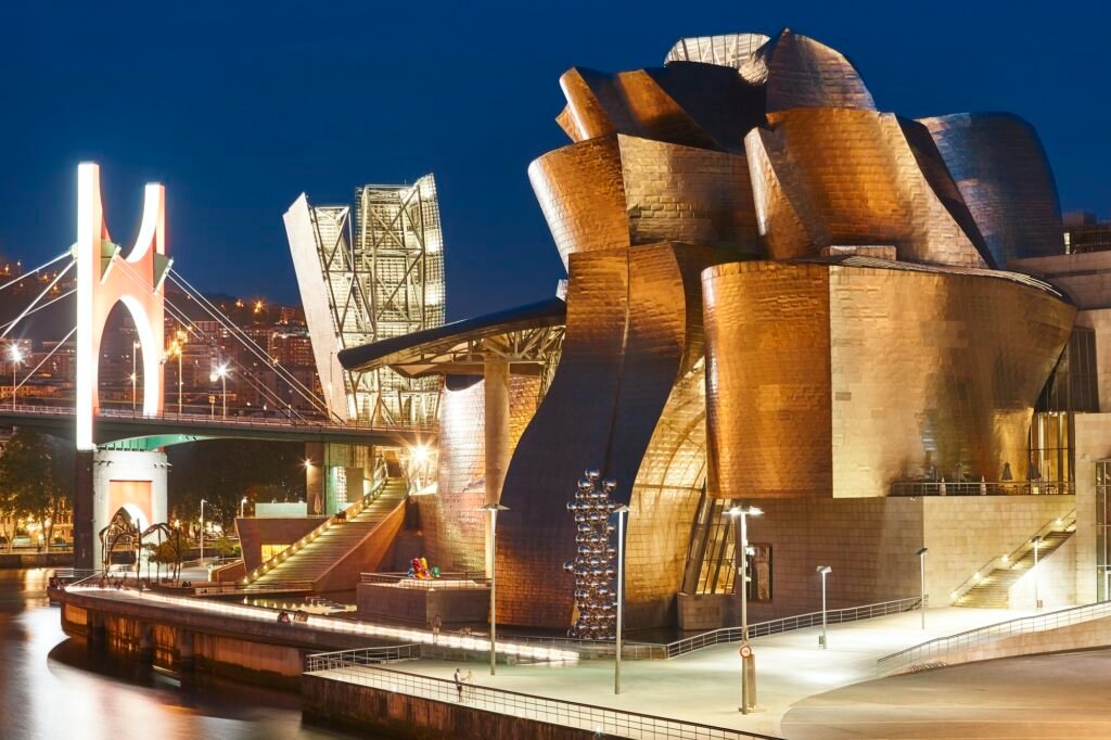 Bilbao downtown Guggenheim museum titanium metallic facade by night. Spain